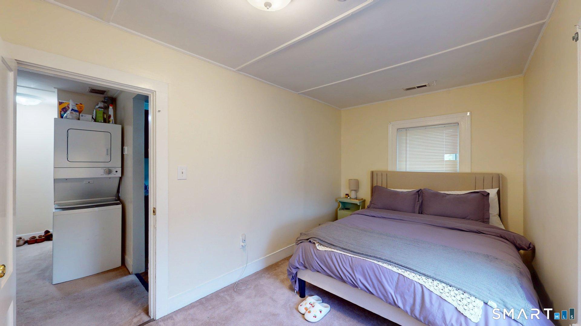 138 Main Street Somers, CT 06071 - Photo 32 of 40 a bedroom with a bed and a refrigerator