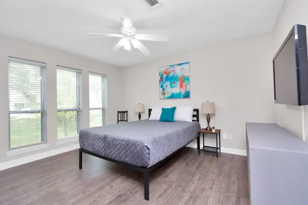 a bedroom with a bed and a flat screen tv