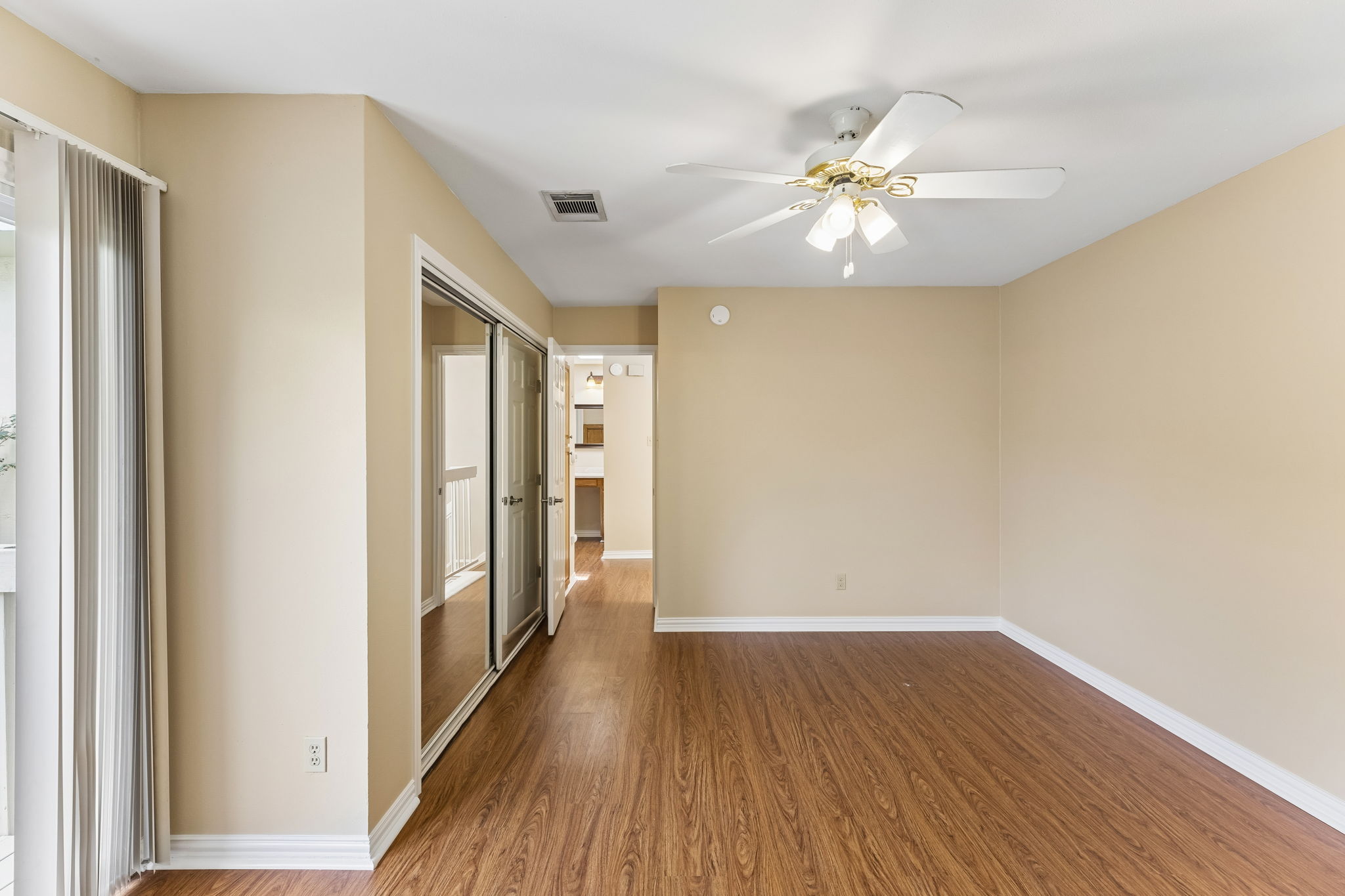 8340 Fathom Circle, Unit 103 Austin, TX 78750 - Photo 27 of 30 a very nice looking room with wooden floor and a ceiling fan
