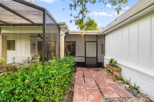 a view of a house with potted plants
