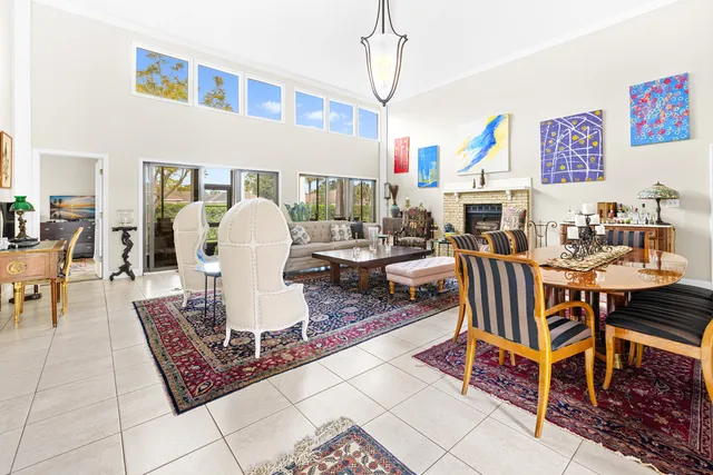 a living room with furniture a dining table and a bookshelf