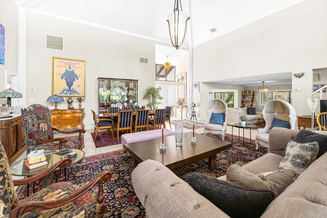 a living room with furniture fireplace and a chandelier