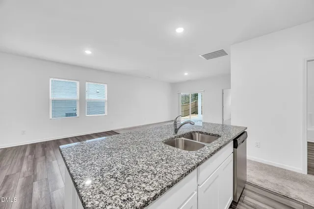 a kitchen with a sink and granite top