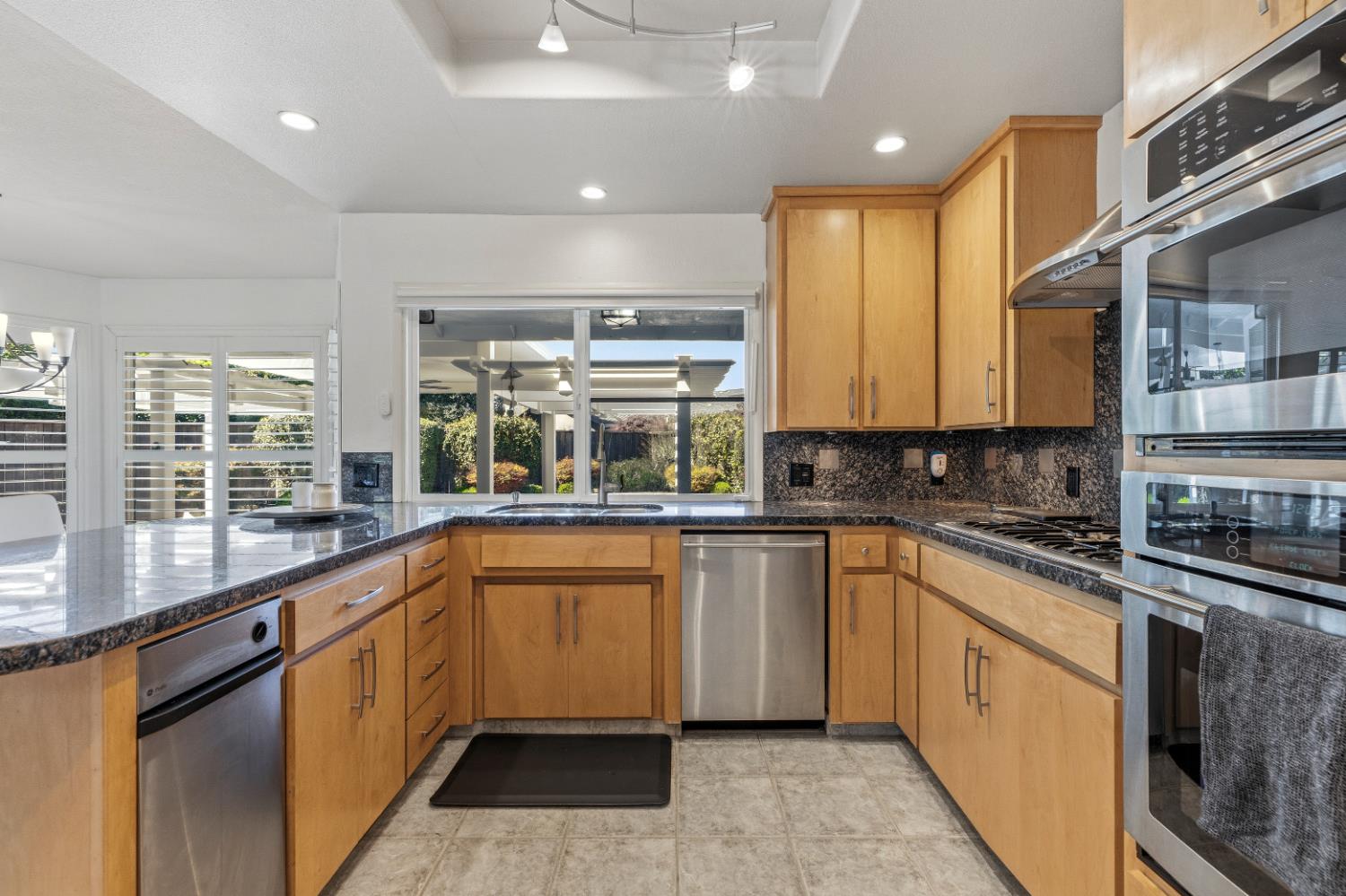 908 Newcastle Court Modesto, CA 95355 - Photo 11 of 25 a large kitchen with stainless steel appliances granite countertop a stove and a sink