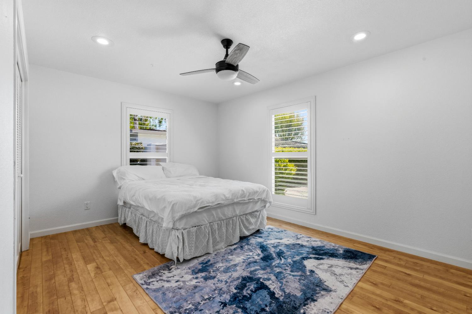 908 Newcastle Court Modesto, CA 95355 - Photo 13 of 25 a bedroom with a bed and a window with wooden floor