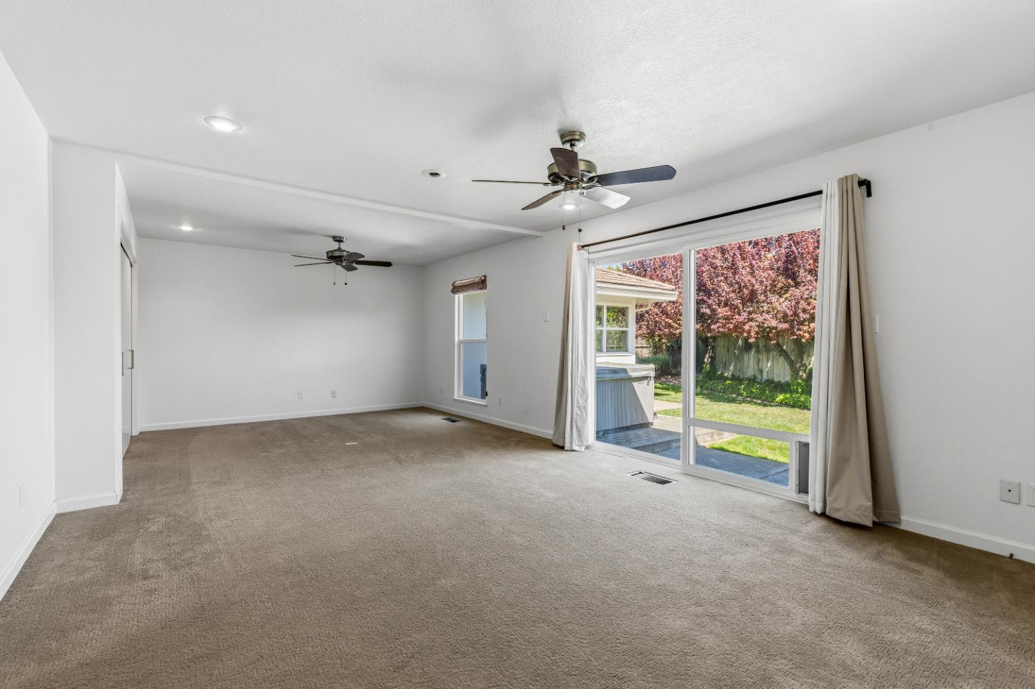 908 Newcastle Court Modesto, CA 95355 - Photo 14 of 25 a view of an empty room with a window