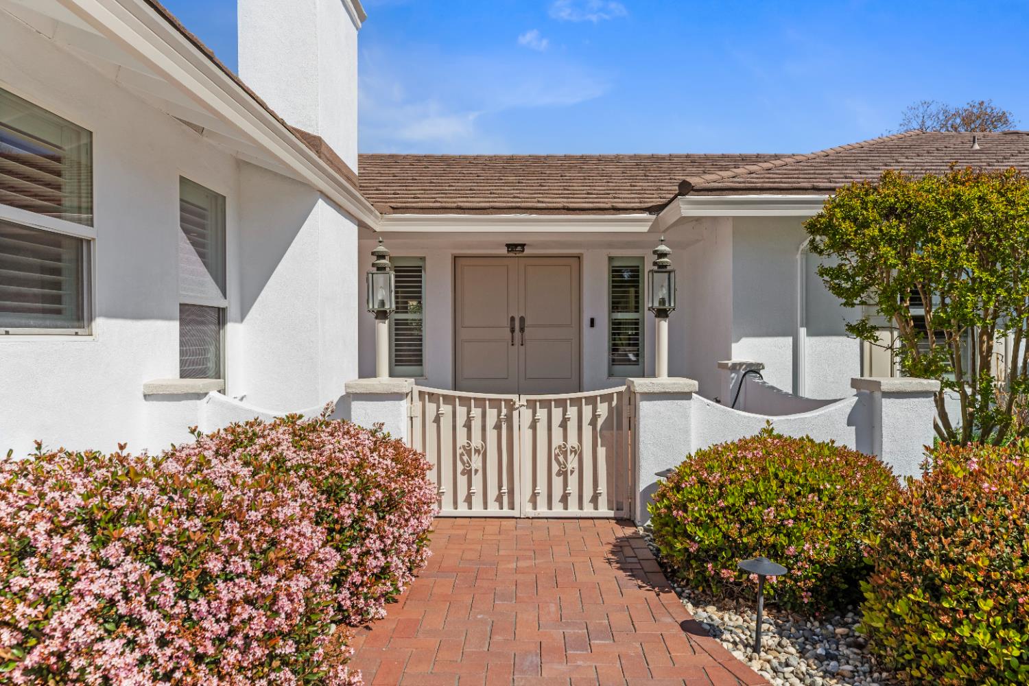 908 Newcastle Court Modesto, CA 95355 - Photo 2 of 25 a view of a house with a large window and potted plants
