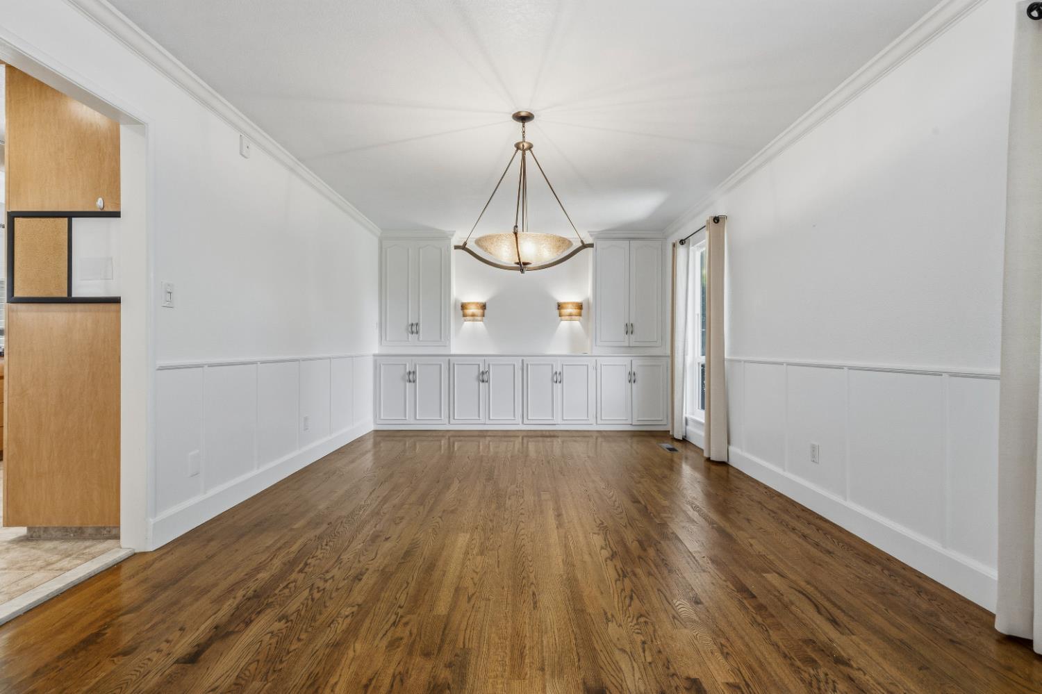 908 Newcastle Court Modesto, CA 95355 - Photo 5 of 25 a view of a room with wooden floor and large windows