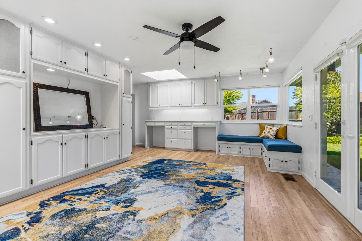 908 Newcastle Court Modesto, CA 95355 - Photo 7 of 25 a living room with stainless steel appliances kitchen island granite countertop furniture a rug and a view of kitchen
