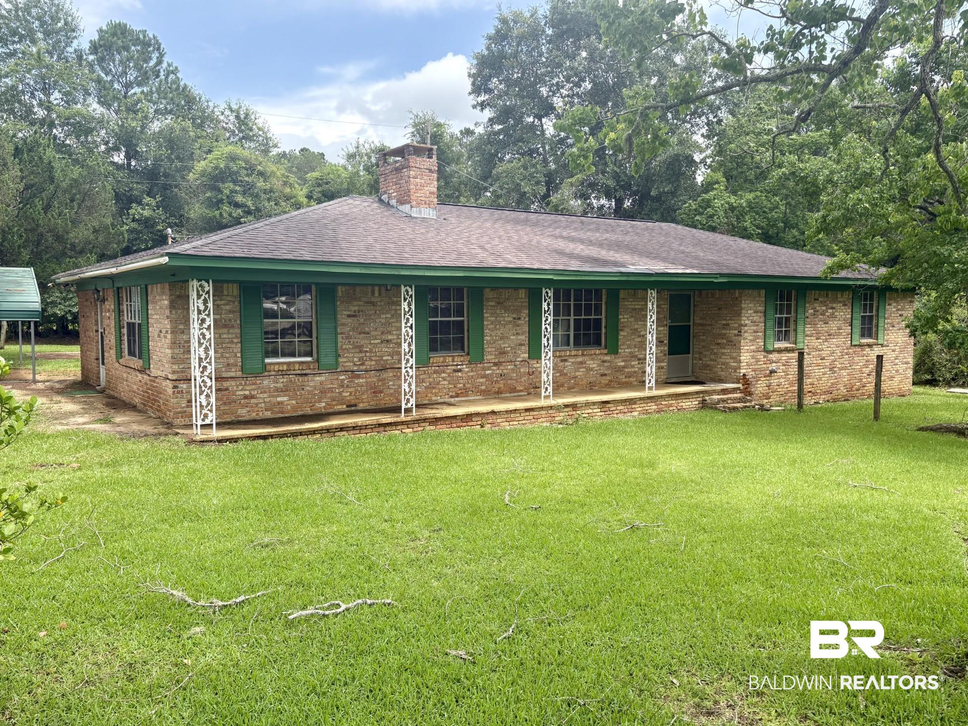 230 Dee Watts Road Bay Minette, AL 36507 - Photo 1 of 2 Brick exterior featuring a covered front porch with decorative white metal columns