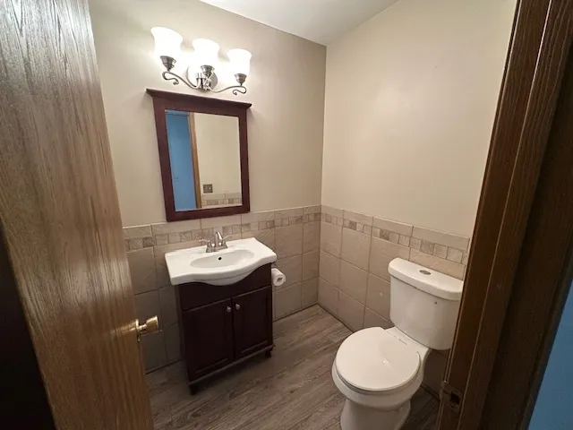 a view of a hallway with wooden floor and entryway