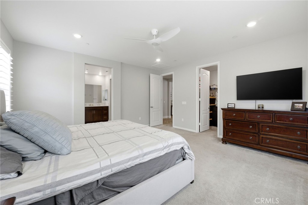 20948 Center Street Riverside, CA 92507 - Photo 52 of 92 a spacious bedroom with a bed and a flat screen tv
