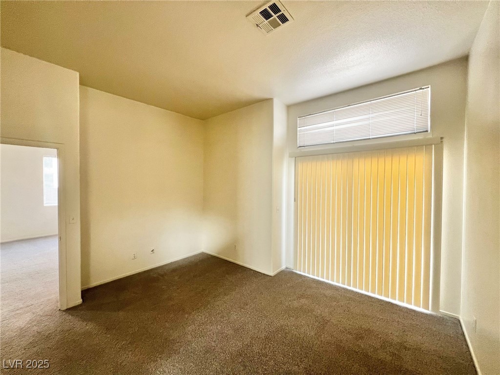 6656 Goldencreek Way, Unit HOME Las Vegas, NV 89108 - Photo 11 of 22 Spare room featuring dark carpet and baseboards