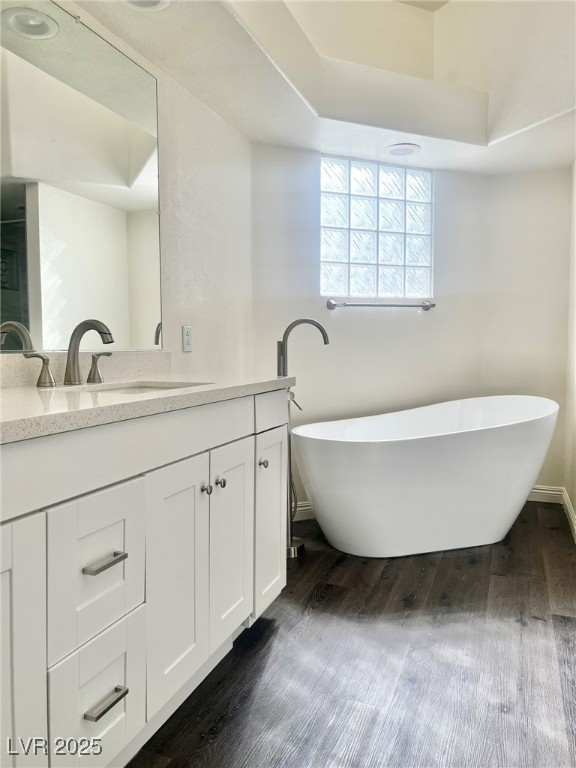 6656 Goldencreek Way, Unit HOME Las Vegas, NV 89108 - Photo 12 of 22 Full bathroom featuring a freestanding tub, vanity, and dark wood-type flooring