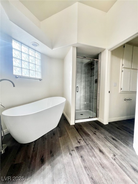 6656 Goldencreek Way, Unit HOME Las Vegas, NV 89108 - Photo 13 of 22 Bathroom with a freestanding tub, a shower stall, and wood finished floors