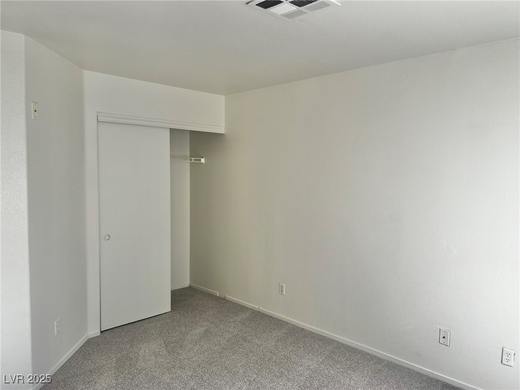 6656 Goldencreek Way, Unit HOME Las Vegas, NV 89108 - Photo 19 of 22 Unfurnished bedroom with carpet and a closet