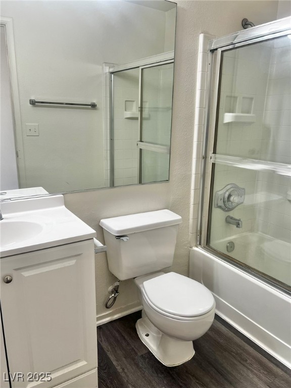 6656 Goldencreek Way, Unit HOME Las Vegas, NV 89108 - Photo 22 of 22 Bathroom with a textured wall, dark wood-style flooring, bath / shower combo with glass door, and vanity