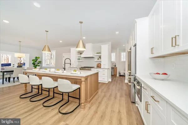 a large kitchen with kitchen island a sink stainless steel appliances and cabinets