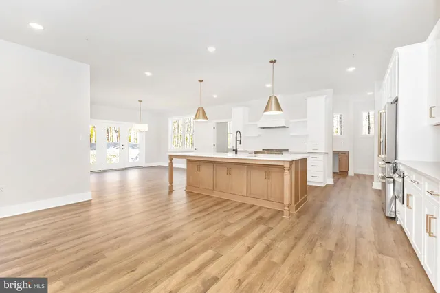 a view of empty room with wooden floor and fireplace