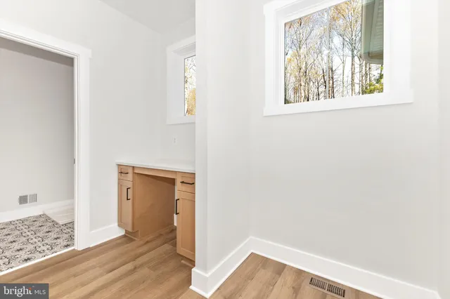 a spacious bathroom with a double vanity sink a mirror and a bathtub