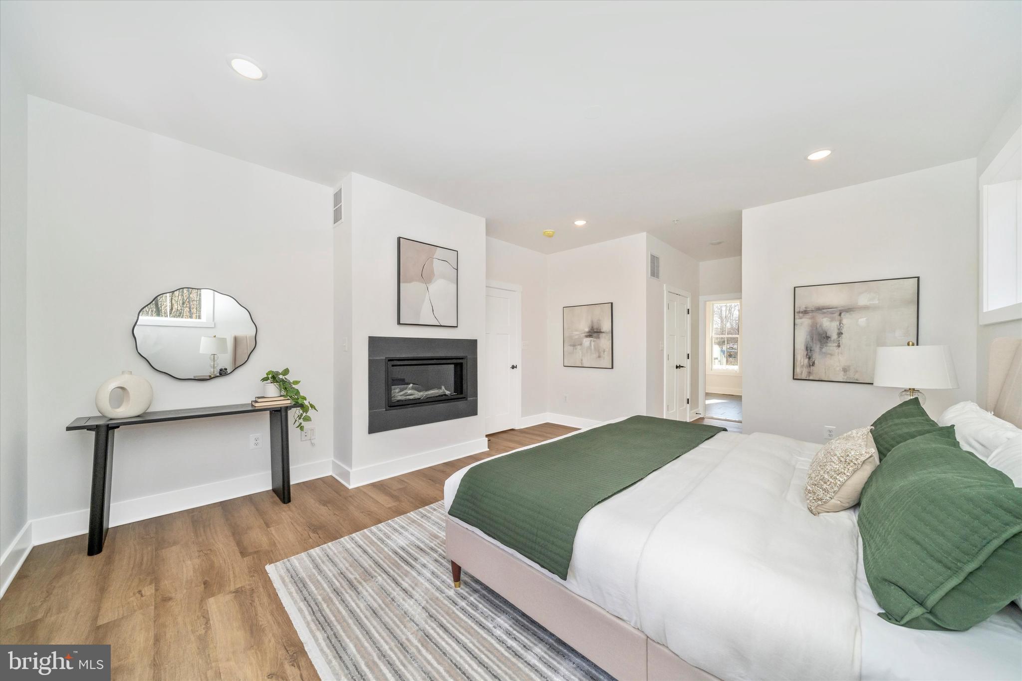 204 3 Rivers Road Harwood, MD 20776 - Photo 24 of 62 a spacious bedroom with a bed and a fireplace