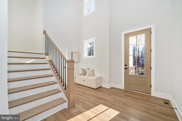 a view of an entryway with wooden floor and windows