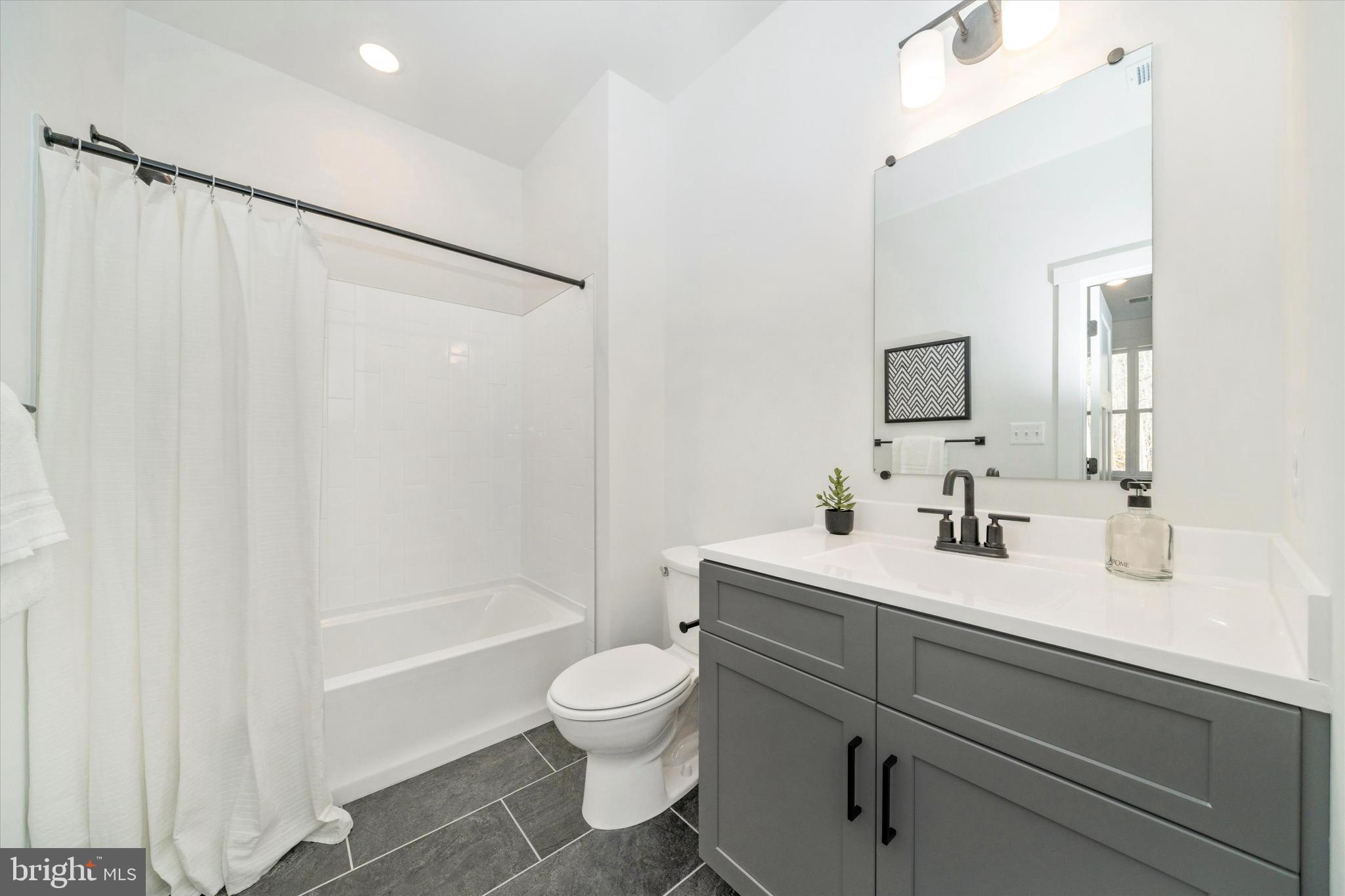 204 3 Rivers Road Harwood, MD 20776 - Photo 33 of 62 a bathroom with a sink a toilet and shower