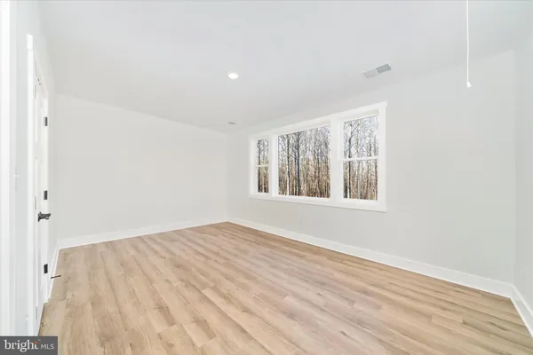 a view of an empty room and wooden floor