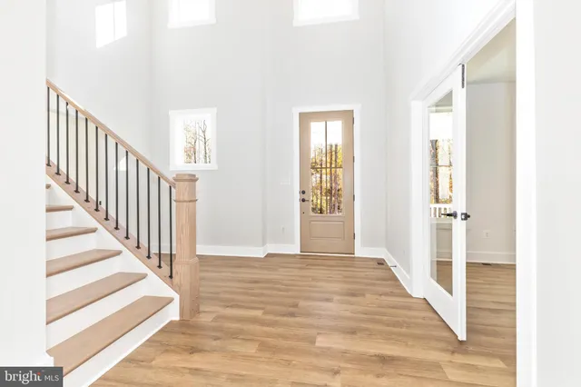 a kitchen with kitchen island a stove a sink and a wooden floors