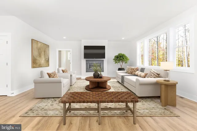 a big room with wooden floor and a window