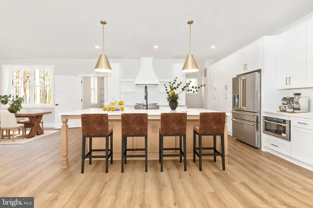 a view of empty room with wooden floor and fireplace