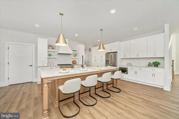 a large kitchen with kitchen island a sink counter space and stainless steel appliances