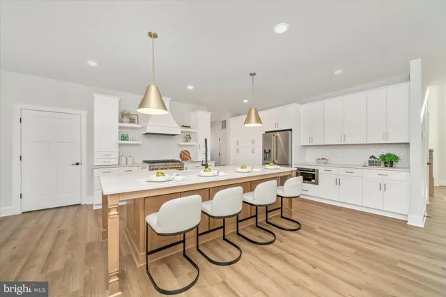 a large kitchen with kitchen island a sink counter space and stainless steel appliances