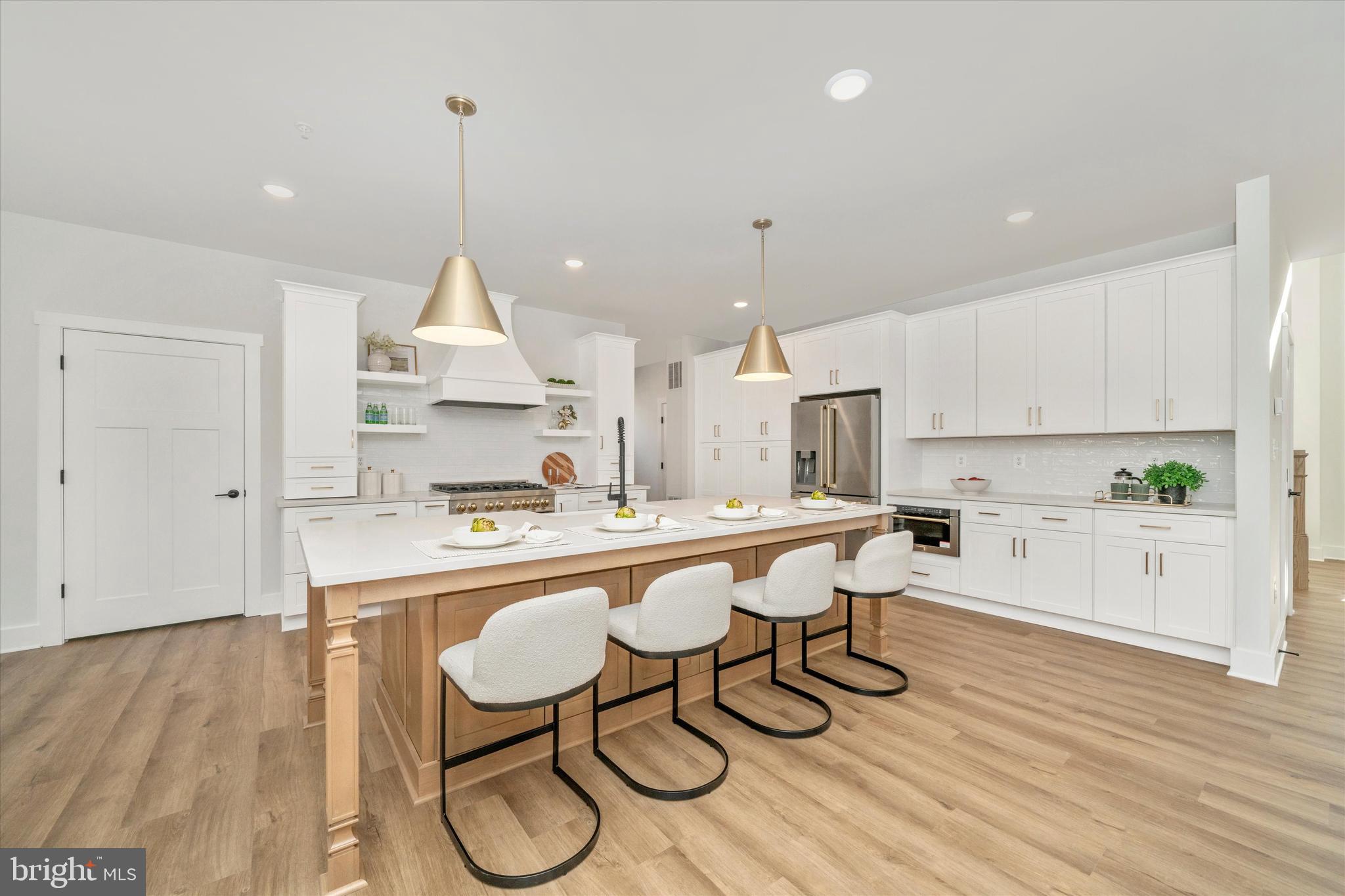 204 3 Rivers Road Harwood, MD 20776 - Photo 10 of 62 a kitchen with stainless steel appliances granite countertop a table chairs in it and white cabinets