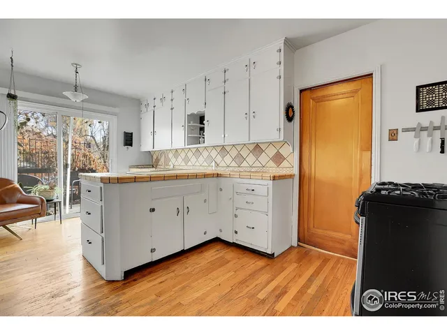 a kitchen with a cabinets and wooden floor