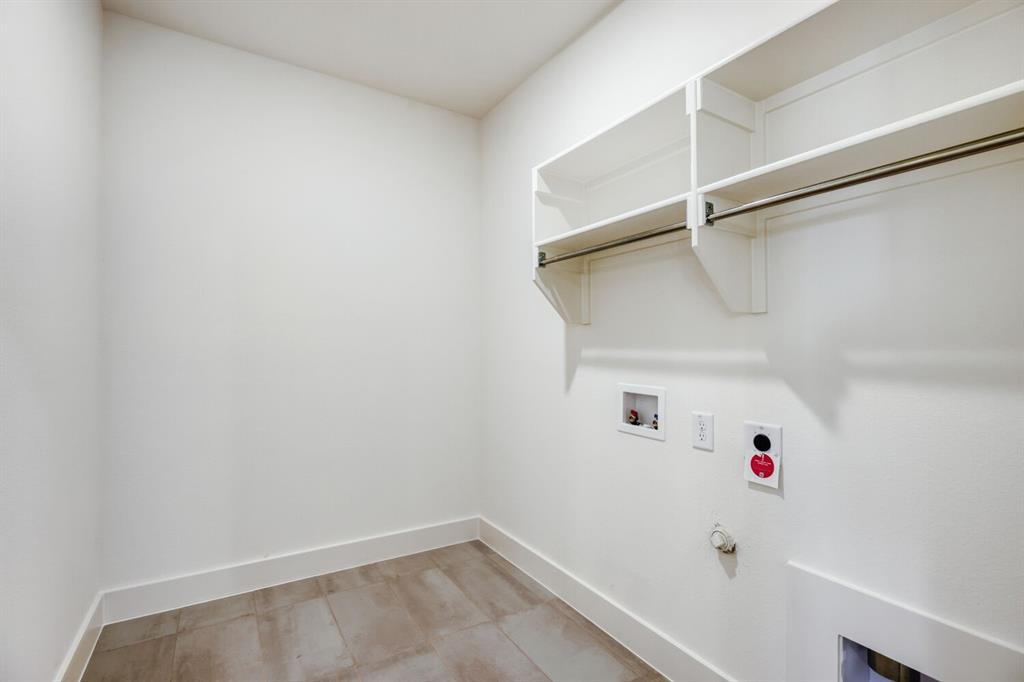 4314 Haley Way Oak Point, TX 75068 - Photo 23 of 28 Utility room featuring built-in shelving, hanging rod, neutral wall paint, tile flooring, and baseboard trim