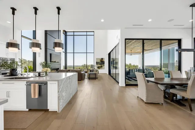 a living room with furniture large windows and a flat screen tv