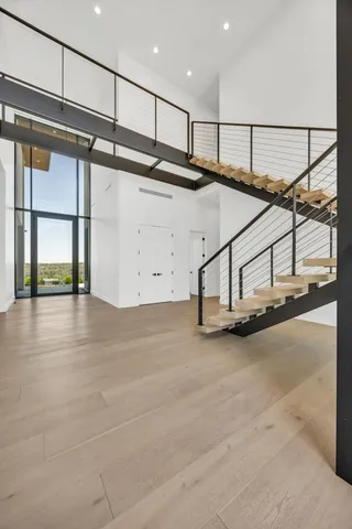 a living room with furniture and a floor to ceiling window