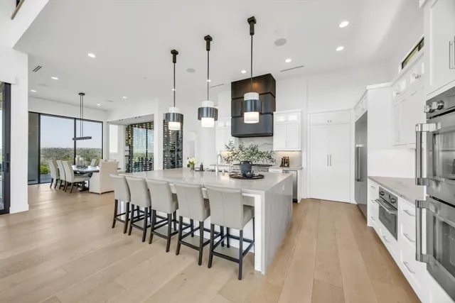 a large bedroom with a bed and a large mirror next to a window