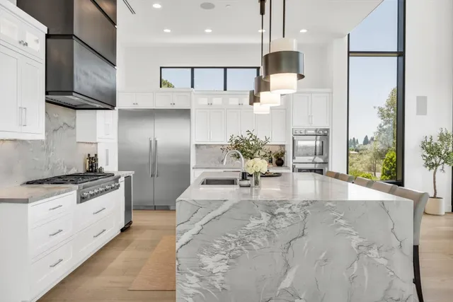 a bedroom with a large bed and a flat tv screen on dresser
