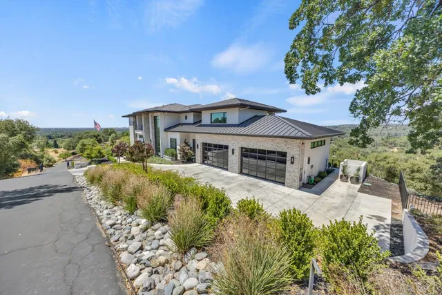 a large kitchen with stainless steel appliances kitchen island granite countertop a stove a sink and a granite counter tops