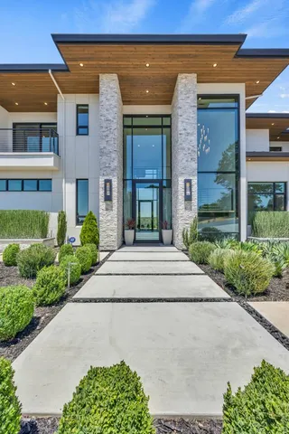 a large kitchen with stainless steel appliances kitchen island granite countertop a stove a sink and a granite counter tops