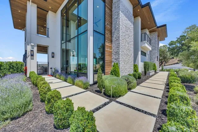 a living room with furniture large windows and a flat screen tv