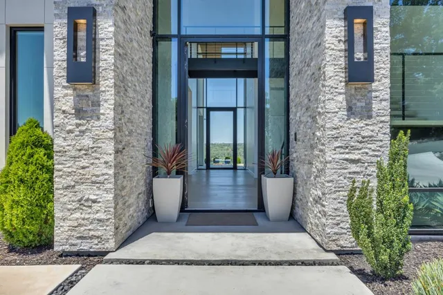 a kitchen with stainless steel appliances granite countertop a sink a stove and refrigerator