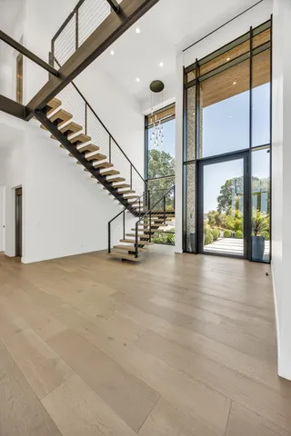 a living room with furniture a large window and a fireplace
