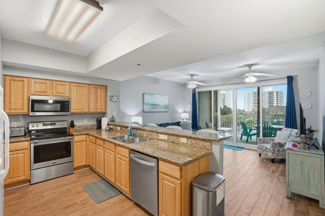 a kitchen with stainless steel appliances granite countertop a stove and a sink