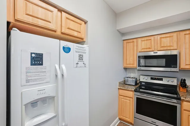 a kitchen with a refrigerator stove and microwave