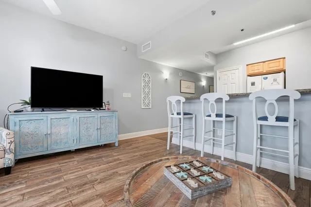 a living room with lots of furniture and wooden floor