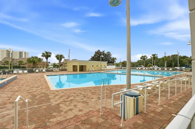 a view of a swimming pool with a lawn chairs