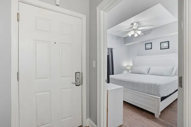 a bedroom with a bed and a chandelier